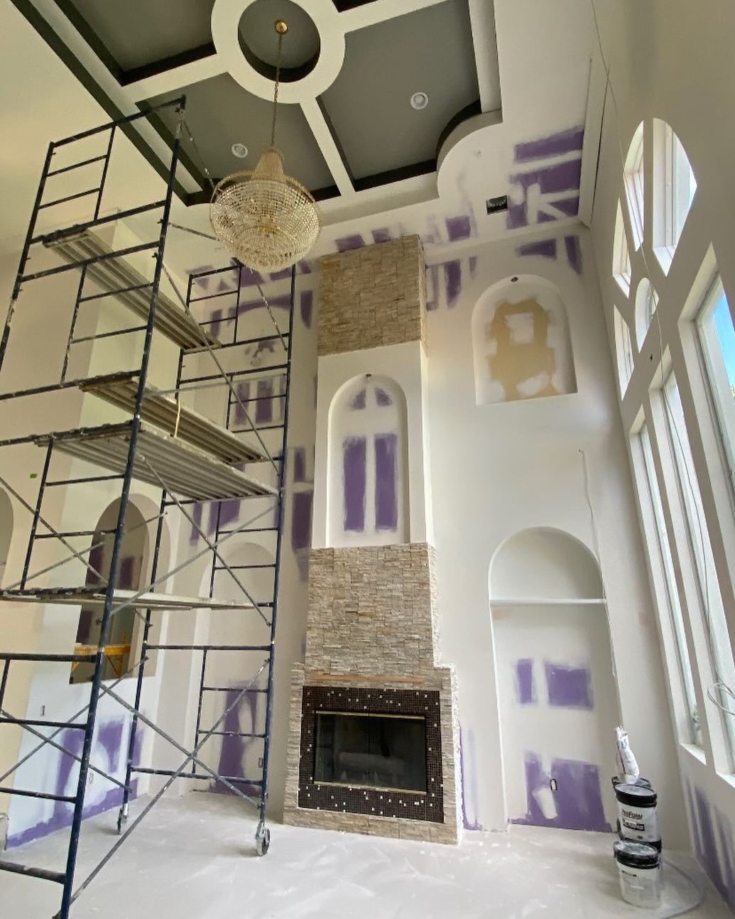 Custom drywall finishing in a luxury home with double-height ceilings